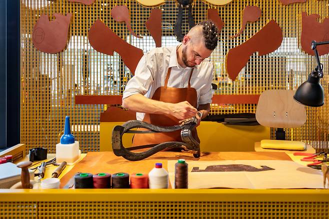 An Hermes artisan from France works on a horse saddle. (Hermes Korea Limited)