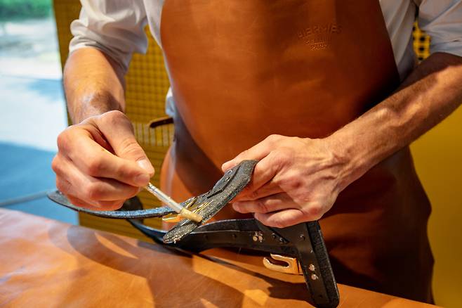 An Hermes artisan from France works on a horse saddle. (Hermes Korea Limited)