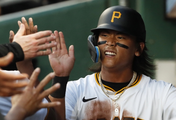 BASEBALL-MLB-PIT-SF/ - May 21, 2024; Pittsburgh, Pennsylvania, USA;  Pittsburgh Pirates center fielder Ji  Hwan Bae (3) high-fives in the dugout after scoring a run against the San Francisco Giants during the fifth inning at PNC Park. Mandatory Credit: Charles LeClaire-USA TODAY Sports