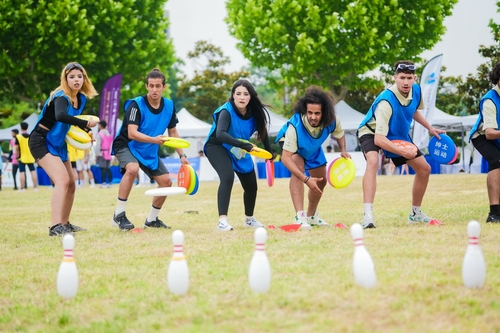 Young athletes from various countries are participating in the outdoor competition.