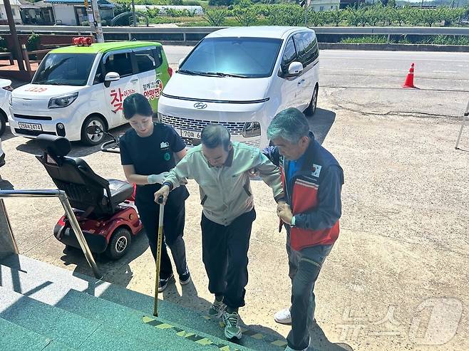 의성군 '찾아가는 통합 이동 진료'팀이 거동이 불편한 어르신을 검진하고 부축하고 있다(의성군 제공)2024.6.5/뉴스1