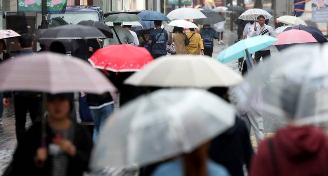 7일은 전국이 맑다가 늦은 오후부터 일부 지역에 소나기가 내리겠다. 시민들이 갑작스러운 비에 우산을 들고 분주히 이동하고 있다. /사진=뉴시스