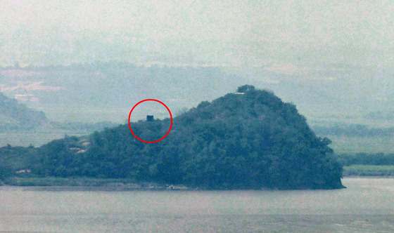 A new structure that appears to be a massive loudspeaker near a North Korean guard post on the Imjin River in Kaepung County, North Hwanghae Province, is circled in red in this photograph taken from Odusan Unification Observatory in Paju, Gyeonggi, on Tuesday. [NEWS1]