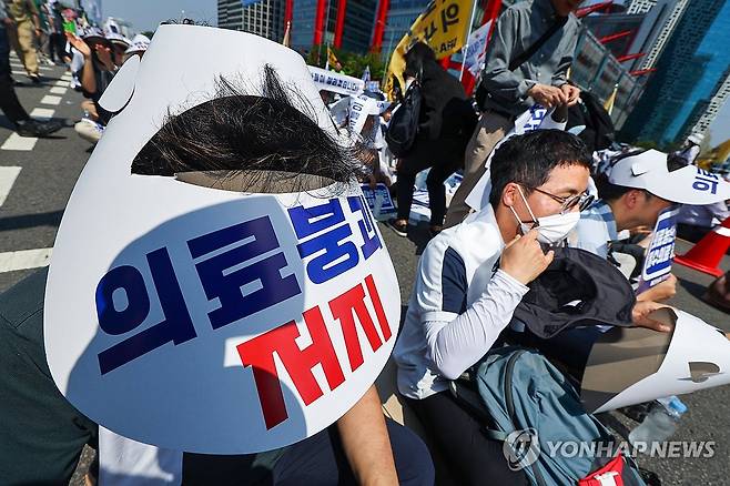 더위에도 거리로 나선 의사들 (서울=연합뉴스) 서대연 기자 = 대한의사협회(의협)의 주도로 개원의와 일부 의대 교수들이 집단휴진에 나선 18일 오후 서울 영등포구 여의대로에서 열린 전국 의사 총궐기대회에서 참가자들이 모자를 쓰고 있다. 2024.6.18 dwise@yna.co.kr