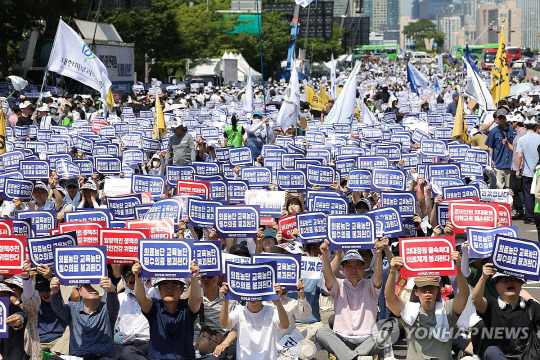 18일 오후 서울 영등포구 여의대로에서 열린 전국 의사 총궐기대회에서 참가자들이 피켓을 들고 구호를 외치고 있다. <사진: 연합뉴스>