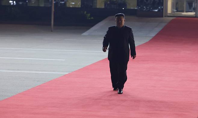 North Korean leader Kim Jong-un walks down the red carpet to greet Russian President Vladimir Putin at the Pyongyang Sunan International Airport outside Pyongyang, North Korea, on Tuesday. (Vladimir Smirnov, Sputnik, Kremlin Pool Photo via AP)