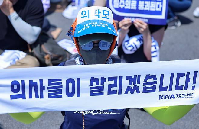 대한의사협회(의협)의 주도로 개원의와 일부 의대 교수들이 집단휴진에 나선 18일 오후 서울 영등포구 여의대로에서 열린 전국 의사 총궐기대회에서 의대생 학부모들이 현수막을 들고 있다. ⓒ연합뉴스