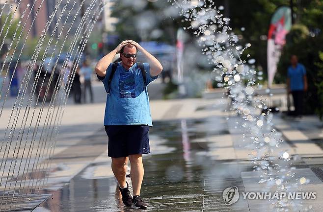 분수길 걸으며 더위 날려요 (서울=연합뉴스) 김혜인 기자 = 올해 첫 폭염특보가 내려진 19일 오후 서울 광화문 광장에서 외국인 관광객이 분수 사이를 지나며 더위를 식히고 있다. 2024.6.19 in@yna.co.kr