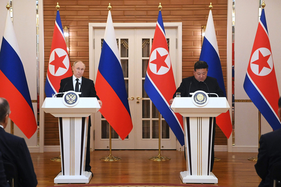 Russian President Vladimir Putin and North Korean leader Kim Jong-un speak to the media following their bilateral talks at Kumsusan state residence in Pyongyang on Wednesday. [AFP/YONHAP]