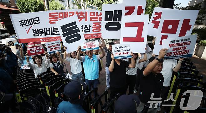 평통사와 겨레하나 등 시민단체 관계자들이 25일 오전 서울 동대문구 한국국방연구원에서 열린 제12차 한미 방위비분담금특별협정(SMA) 체결을 위한 4차 회의를 앞두고 굴욕 협상을 규탄하는 피켓을 들고 있다. 22024.6.25/뉴스1 ⓒ News1 오대일 기자