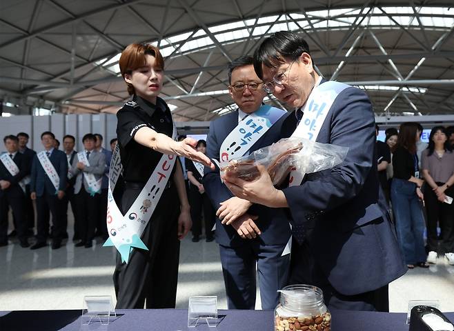 18일 오후 인천국제공항 제1여객터미널 에서 열린 제38회 세계 마약퇴치의 날 기념 마약 퇴치 캠페인 행사에서 김종호 인천공항본부세관장, 정상혁 신한은행장, 인천공항본부세관 마약근절 홍보대사인 방송인 장도연이 건오징어 속 마약 적발 사례를 살펴보고 있다. /사진=연합뉴스