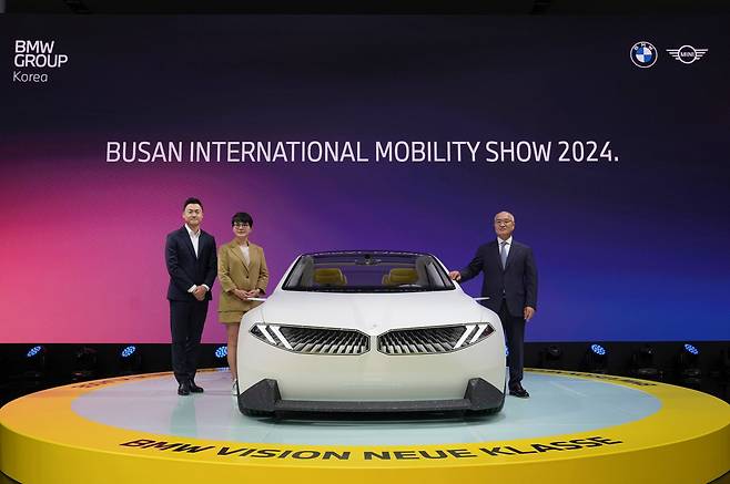 BMW Group Korea officials including President Han Sang-yun (right) pose for a photo with the BMW Vision Neue Klasse at the 2024 Busan International Mobility Show on Thursday. (BMW Group Korea)