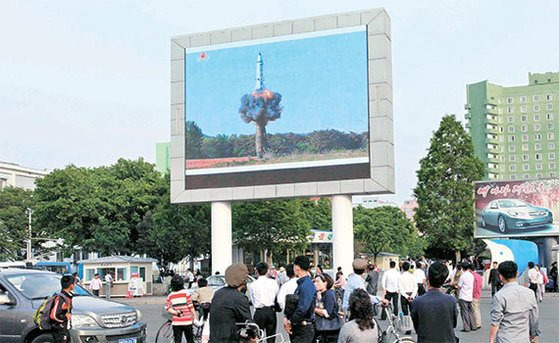 북한 평양 시민들이 평양역 앞에 설치된 대형 스크린을 통해 탄도미사일시험발사 장면을 지켜보고 있다. AP=연합뉴스