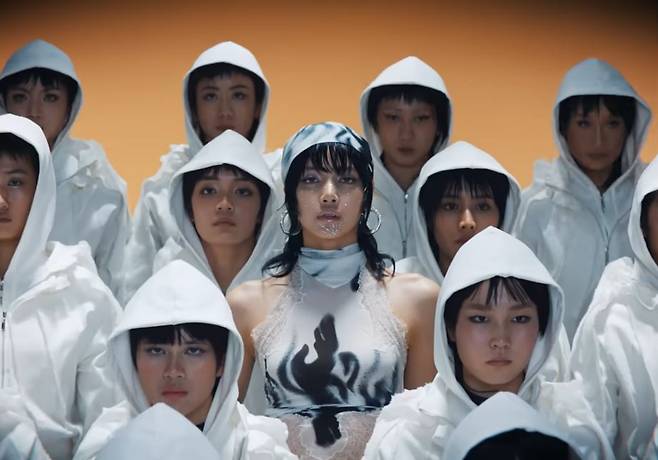 Lisa (center) and Thai dancers are seen in the music video of her new solo single "Rockstar" (Sony Music Entertainment Korea)