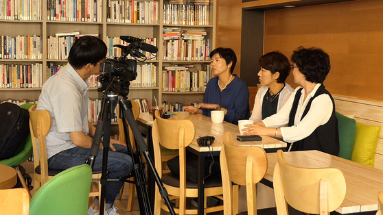 A still image from the film ″A Long Way to School″ shows parents of children with disabilities being interviewed to raise awareness on the issues they face. [JINJIN PICTURES]