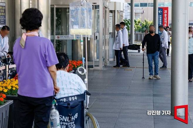 서울대병원 교수들이 전공의 사태 해결 등을 요구하며 무기한 휴진에 돌입한 17일 서울 종로구 서울대병원에서 환자와 환자 가족이 의료진을 바라보고 있다. 사진=강진형 기자aymsdream@