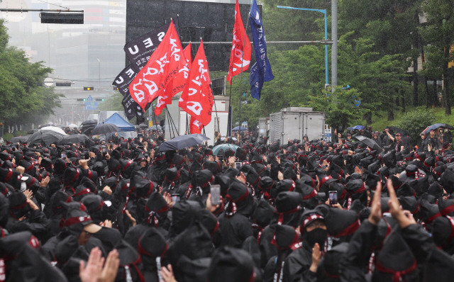 ▲ 8일 오전 경기도 화성시 삼성전자 화성사업장 앞에서 열린 전국삼성전자노동조합 총파업 결의대회에서 조합원들이 입장하는 깃발을 보며 박수치고 있다. 연합뉴스