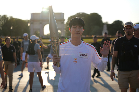 Jin waits to receive the Olympic torch in Paris on July 14. [BIGHIT MUSIC]