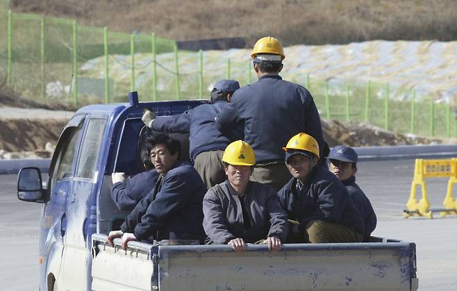 North Korean workers travel on a truck in the street of Kaesong Industrial Complex on February 27, 2006 in Kaesong, North Korea. (Getty Images)