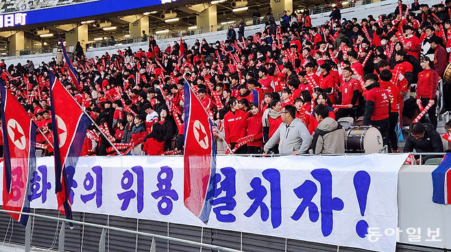 친북 단체 총련 산하인 일본 조선대학교 학생 등이 올 3월 21일 도쿄 국립경기장에서 열린 북한과 일본의 2026 북중미 월드컵 2차 예선에서 인공기를 들고 북한 팀을 열렬히 응원하고 있다.  도쿄=이상훈 특파원 sanghun@donga.com