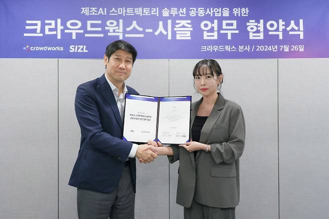 김우승 크라우드웍스 대표(왼쪽)와 이지현 시즐 대표가 기념사진을 촬영하고 있다.(사진=크라우드웍스)