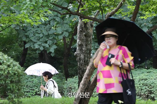 전국 대부분 지역에 폭염 특보가 발효된 24일 서울 성동구 서울숲에서 한 시민이 땀을 닦으며 걷고 있다. 한수빈 기자