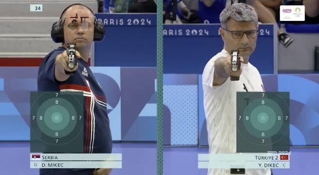 30일(현지시간) 샤토루 슈팅센터에서 열린 사격 혼성 공기권총 10m 금메달 결정전에서 세르비아의 다미르 미케츠(40)와 튀르키예의 유수프 디케츠(51)가 경기하고 있다. (사진=X 갈무리)