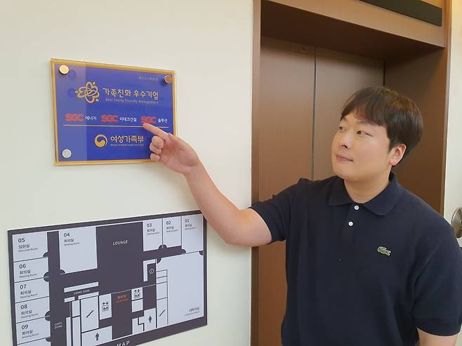 이진수 대리가 가족친화 우수기업 현판을 가리키고 있다. 윤현주 기자