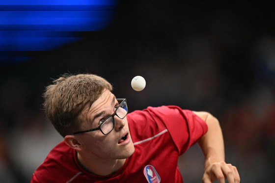 France's Alexis Lebrun eyes the ball during the men's table tennis team quarterfinals against Brazil in Paris, France on Wednesday.  [AFP/YONHAP]