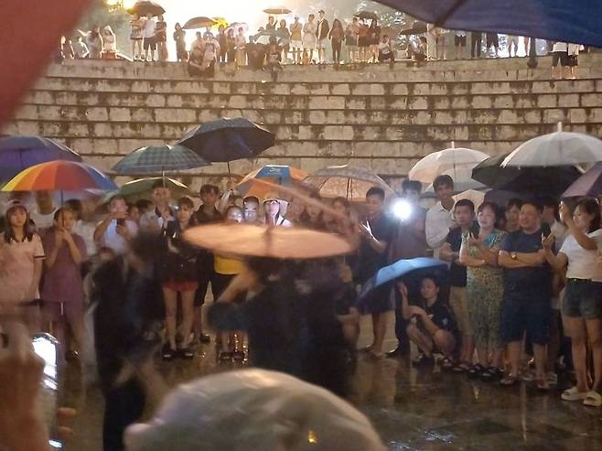 사파 공터에서 우산을 활용한 거리 공연이 진행중이다.