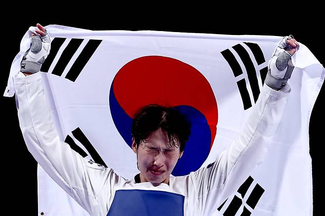 여자 태권도 이다빈이 11일(한국시간) 프랑스 파리의 그랑팔레에서 열린 2024 파리올림픽 태권도 여자 67㎏초과급에서 동메달을 따낸 뒤 태극기를 들고 눈물을 터뜨리고 있다. 사진 | 파리=로이터연합뉴스