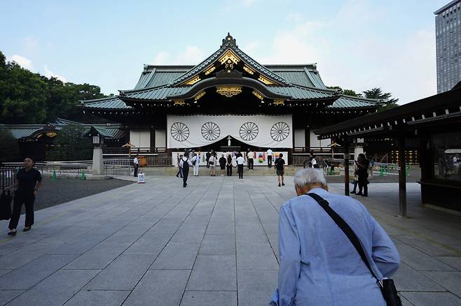 A man bows in front of the main hall of the Yasukuni Shrine, which honors Japan's war dead, in Tokyo on Thursday, as the country marks the 79th anniversary of its defeat in World War II. (AP)