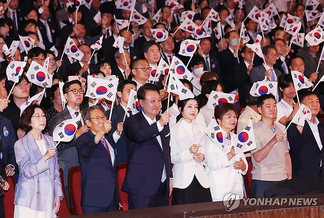 윤석열 대통령 부부, 제79주년 광복절 경축식 참석 (서울=연합뉴스) 진성철 기자 = 윤석열 대통령과 김건희 여사가 15일 서울 종로구 세종문화회관에서 열린 제79주년 광복절 경축식에서 이동일 순국선열유족회장 등 참석자들과 함께 태극기를 흔들고 있다.  2024.8.15   [대통령실통신사진기자단] zjin@yna.co.kr