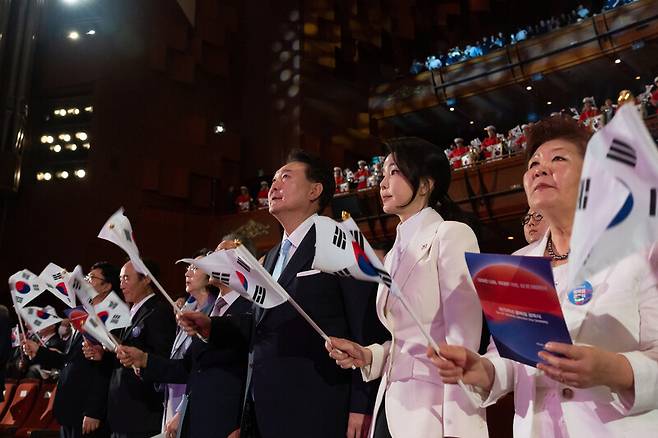 윤석열 대통령과 김건희 여사가 15일 서울 종로구 세종문화회관에서 열린 제79주년 광복절 경축식에서 태극기를 흔들고 있다. 대통령실사진기자단