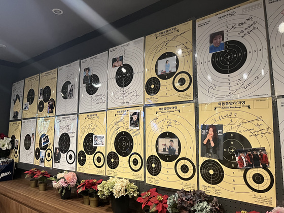 Signed targets line the wall of the Mokdong Shooting Center lounge. [MARY YANG]