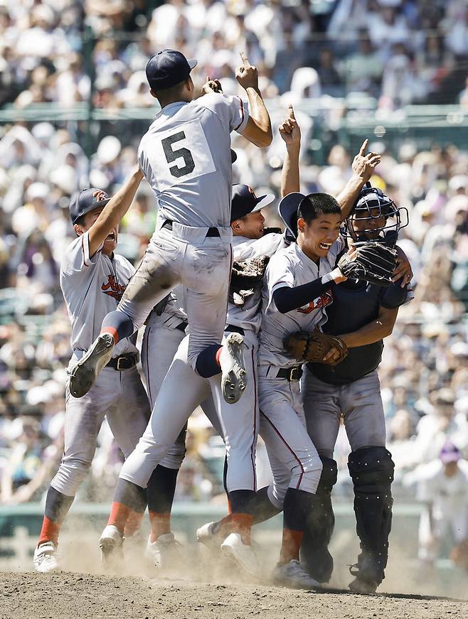 한국계 국제학교인 교토국제고 우익수 하세가와 하야테(등번호 5번)가 23일 일본 효고현 니시노미야 한신고시엔구장에서 열린 전국 고교야구선수권대회(여름 고시엔) 결승전에서 우승을 확정한 뒤 투수 니시무라 잇키(오른쪽에서 두번째) 쪽으로 뛰어오르고 있다. 사진 | 연합뉴스