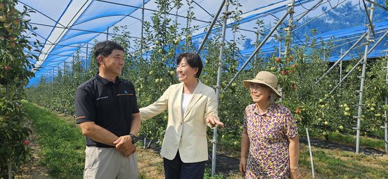 송미령 농림축산식품부 장관(가운데)이 지난 23일 강원도 춘천시 동내면에서 사과와 복숭아를 재배하는 이인영 대풍농원 대표 가족을 만나 사과 작황 등을 주제로 대화를 나누고 있다. 장세정 기자