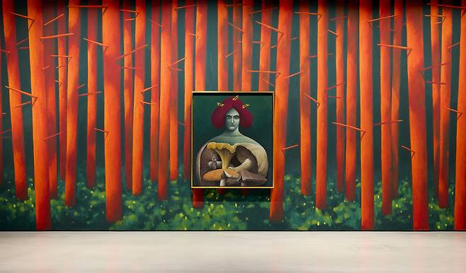 Installation view of ″Nicolas Party: Dust″ at the Hoam Museum of Art. The wall mural is titled ″Tree Trunks,″ and the painting is ″Portrait with Mushrooms″ (2019). [HOAM MUSEUM OF ART]