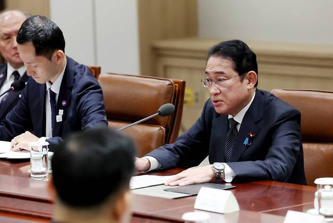 Japanese Prime Minister Fumio Kishida (right) speaks during a summit with South Korean President Yoon Suk Yeol at the presidential office in Seoul on Friday. (Pool photo via Yonhap)