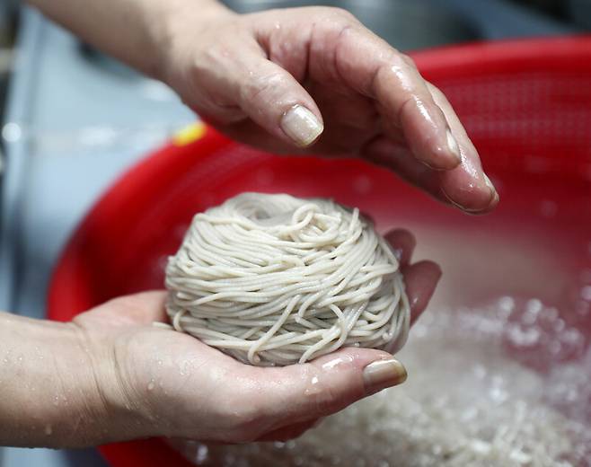 ‘서령’ 창업자 정종문씨가 삶은 면을 말고 있다. 박미향 기자