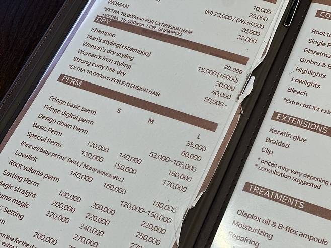 The list of prices for cuts, perms, dying, extensions and other hair treatments is written in English to accommodate English-speaking customers. (The Korea Herald/ Choi Jeong-yoon)