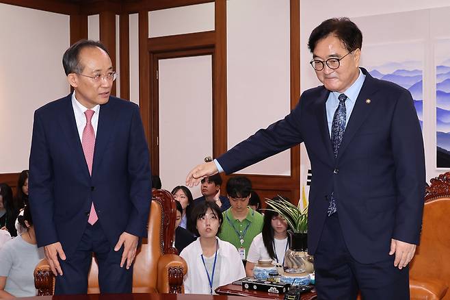 우원식 국회의장(오른쪽)이 19일 국회에서 열린 여야 원내대표 회동에 참석한 추경호 국민의힘 원내대표에게 자리를 안내하고 있다. [사진 출처 = 공동취재단, 연합뉴스]