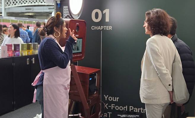 지난 10~11일(현지 시각) 영국 런던 올림피아에서 열린 ‘2024 SFFF(Speciality & Find Food Fair)’의 한국 부스 모습. 한켠에 구비된 즉석 사진기 '인생네컷'에서 참가자들이 사진을 찍고 있다. /박소정 기자