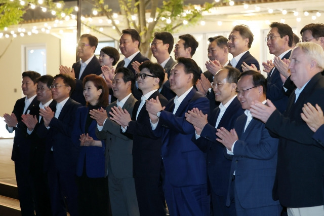 윤석열 대통령이 24일 서울 용산 대통령실 앞 분수정원에서 열린 국민의힘 지도부 초청 만찬 뒤 한동훈 대표, 추경호 원내대표 등 국민의힘 지도부, 대통령실 참모진과 함께 산책을 하고 있다. 대통령실 제공