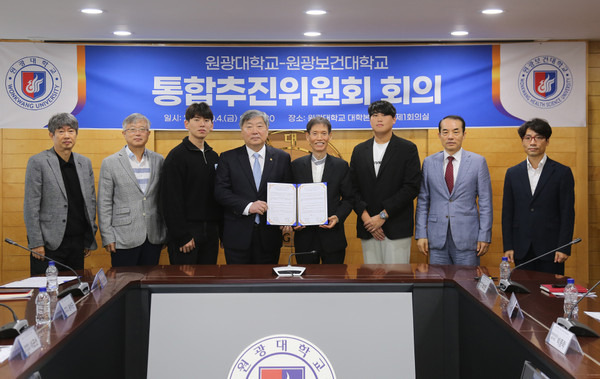 Fourth from left: Wonkwang University President Park Sung-tae and Wonkwang Health Science University President Baek Jun-hum pose for a photo after agreeing to launch the merged university in March 2026 during a meeting on Oct. 4. [WONKWANG UNIVERSITY]