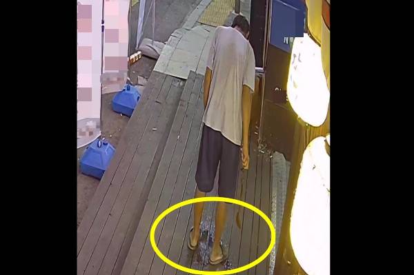 화장실을 안내했음에도 매장 앞에서 바지를 입고 소변을 눈 남성의 모습이 공개됐다. 사진은 가게 앞에서 볼일을 해결하는 해당 남성의 모습. /사진=온라인 커뮤니티 아프니까 사장이다 캡처