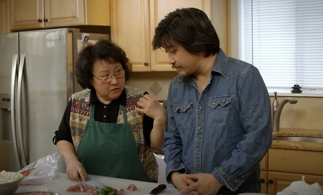Chef Edward Lee (right) cooking with his mother on a YouTube channel. /YouTube