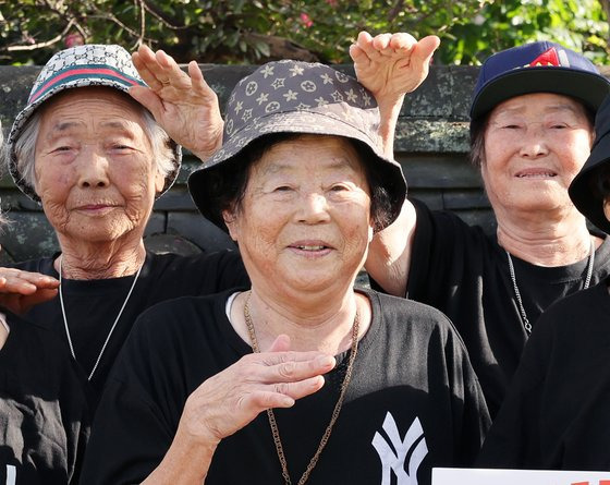 Seo Mu-seok (center) poses for a photo with members of her hip-hop group, in this photo distributed by the Chilgok-gun Office. (Chilgok-gun Office