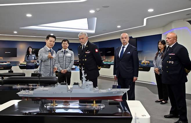 Hanwha Ocean officials brief Tomasz Szubrycht (third from left), commandant of the Polish Naval Academy, on its shipbuilding portfolio at the company’s Geoje shipyard in South Gyeongsang Province, Wednesday. (Hanwha Ocean)