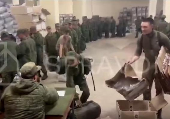 Soldiers believed to be from North Korea are standing in line to receive supplies from Russia on Oct. 19 in a screen capture of video footage released by the Ukrainian Center for Strategic Communication and Information Security, or Spravdi. [SCREEN CAPTURE]